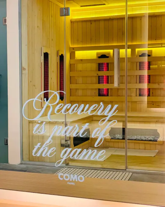 Sauna door etched 'Recovery is part of the game'